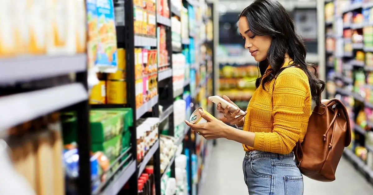 blog-hero-grocery-shopping-tips-Woman-comparing-prices-at-the-grocery-store-1200x630-min