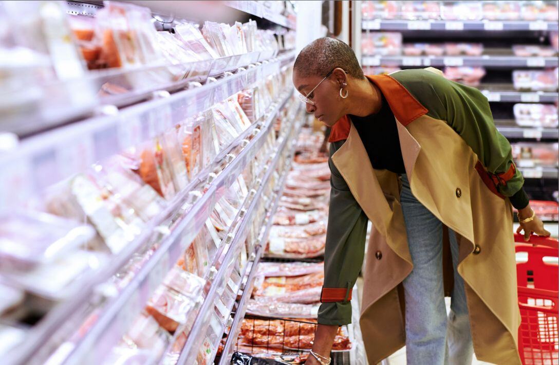 woman shopping meat aisle 